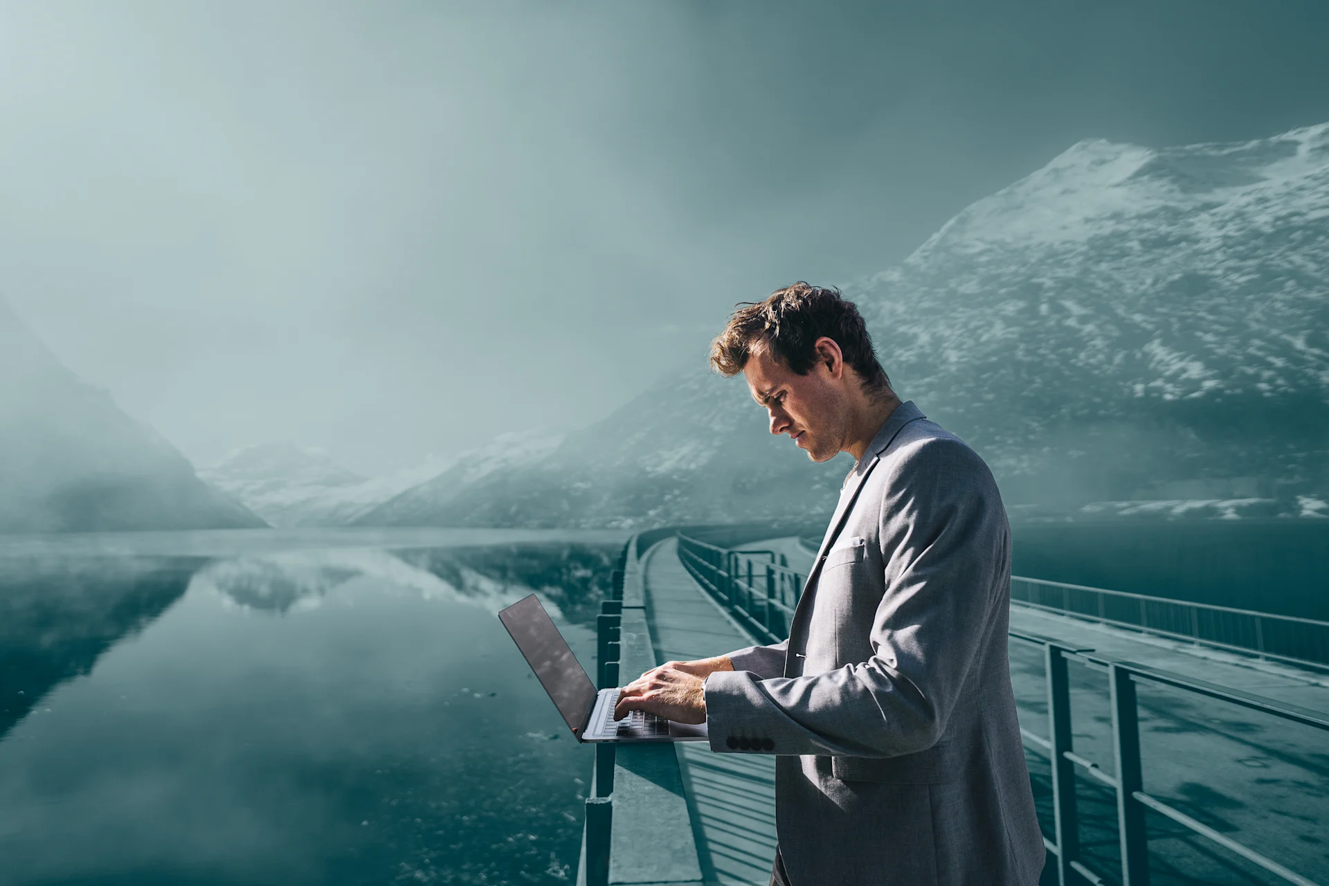 Business man in mountain area using laptop