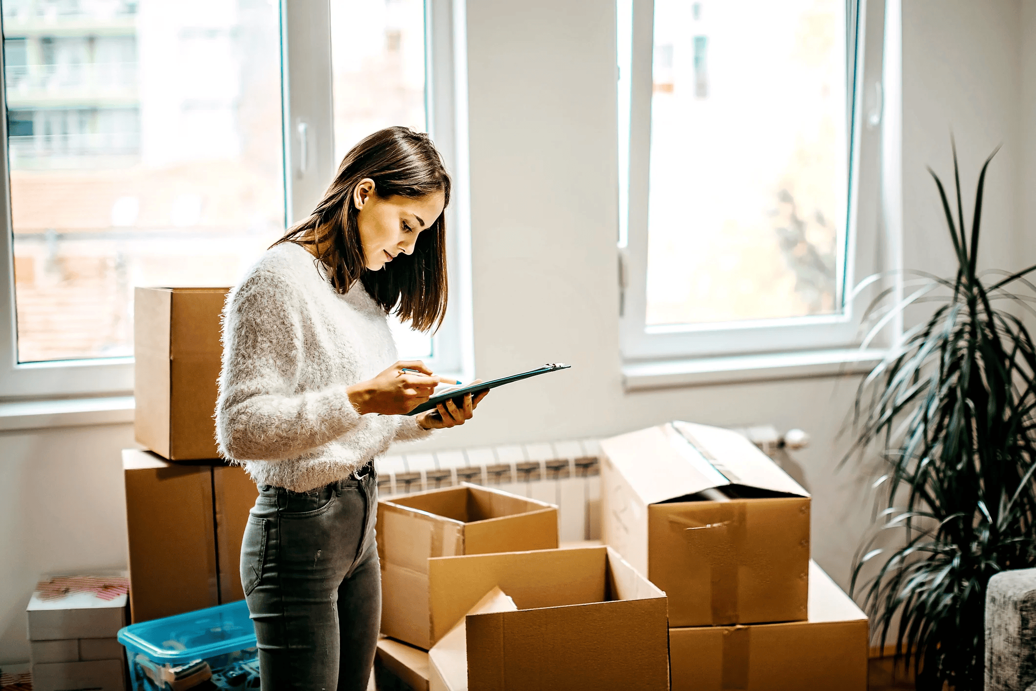 Woman looking at checklist while moving home