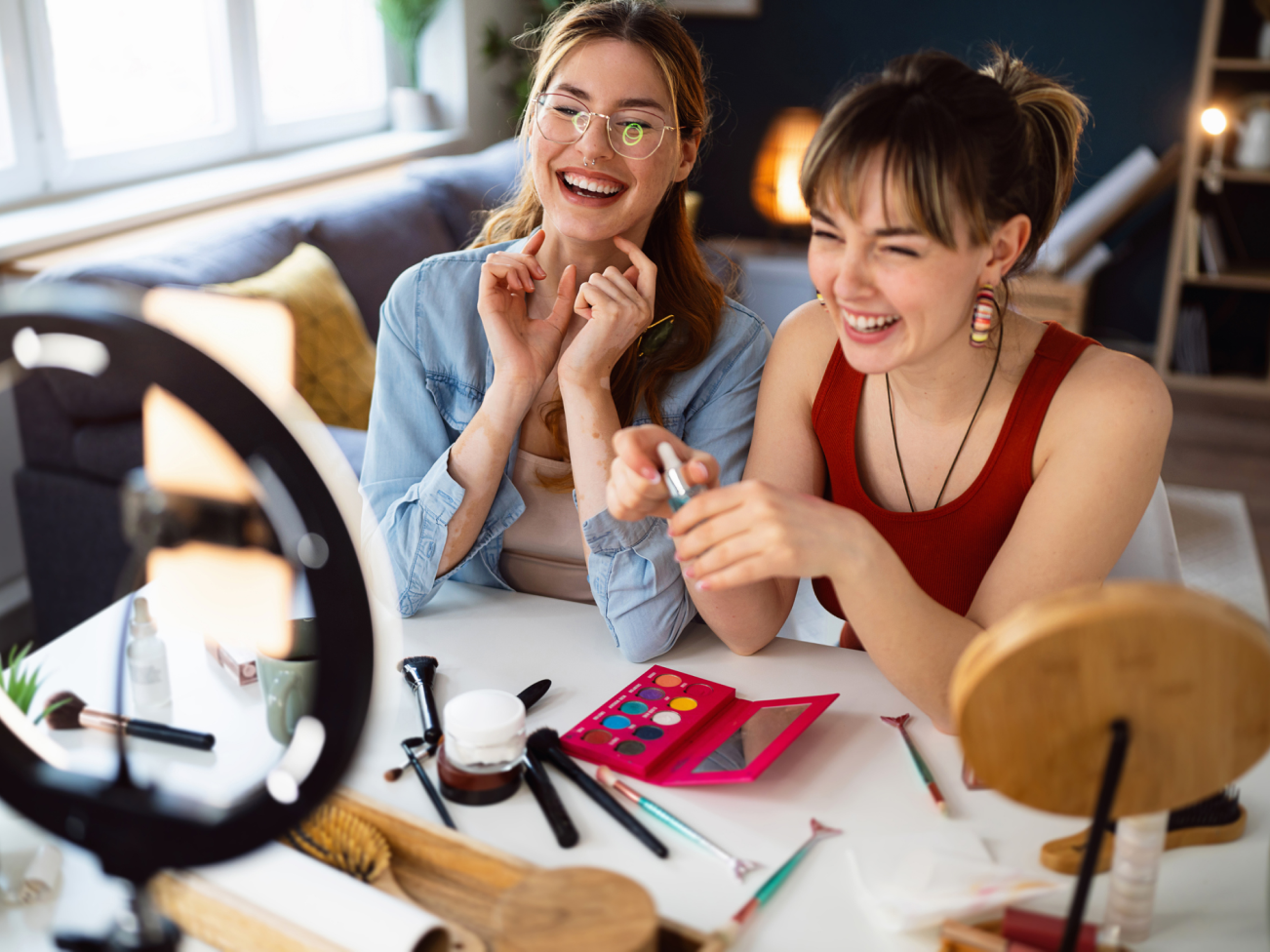 2 women smiling in front of camera