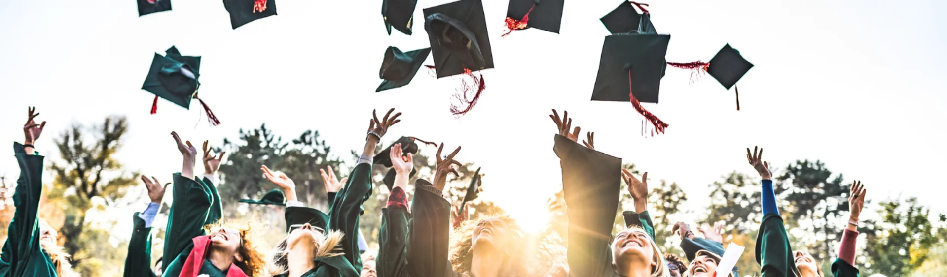 Graduates throwing their hats in the air for graduation