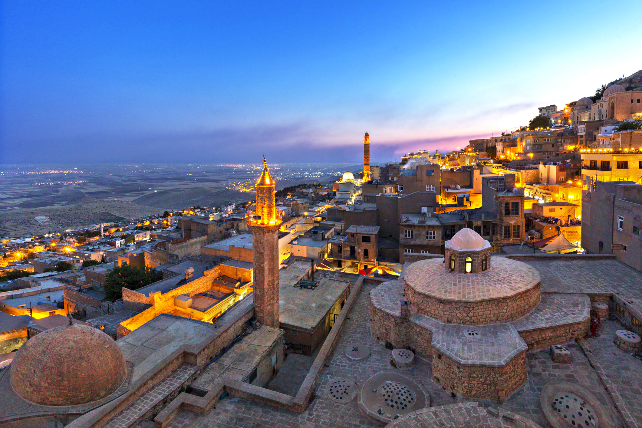 City of Mardin at the Blue Hour, turkey. Deep blue skies and golden lights across the stony city.