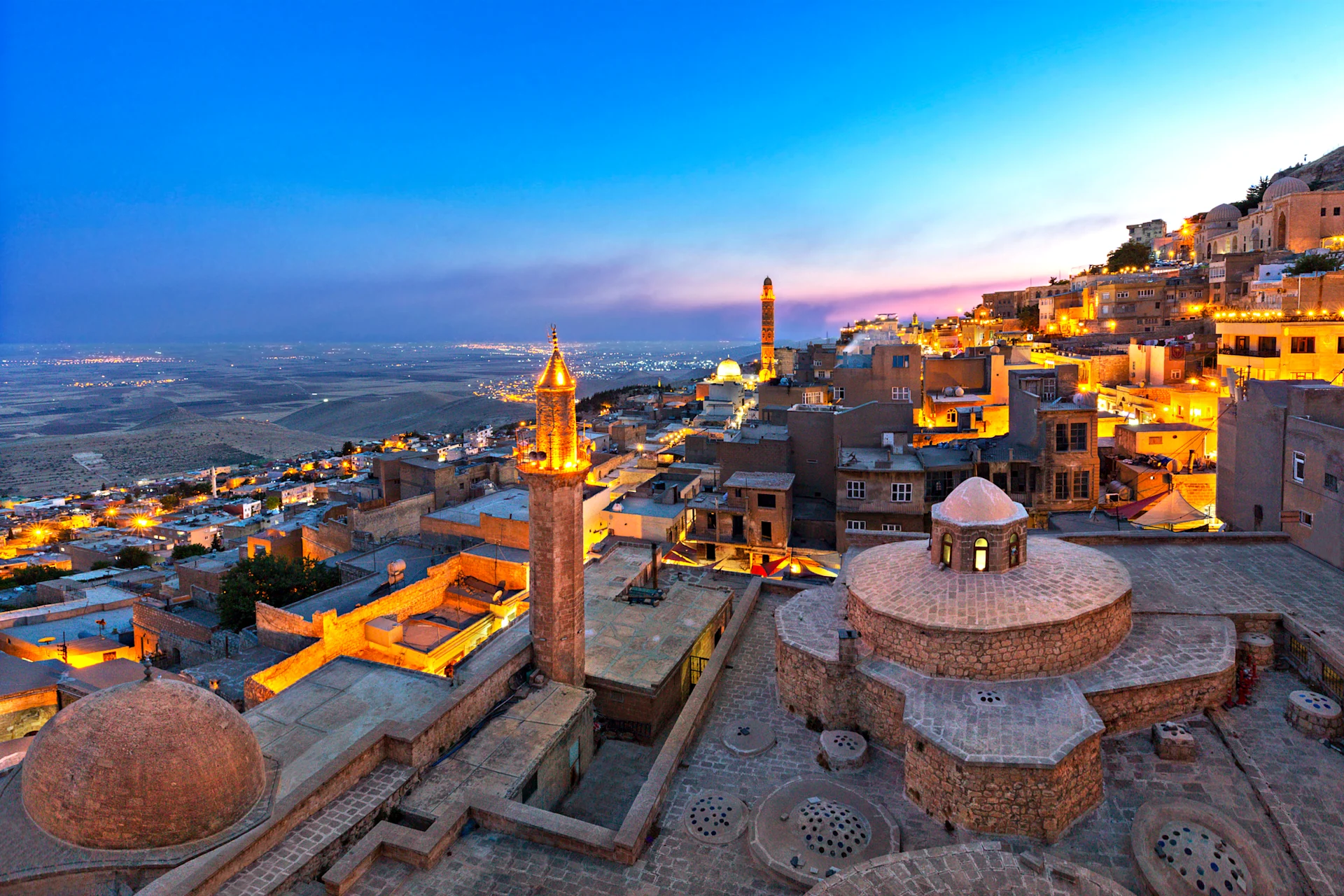 City of Mardin at the Blue Hour, turkey. Deep blue skies and golden lights across the stony city.