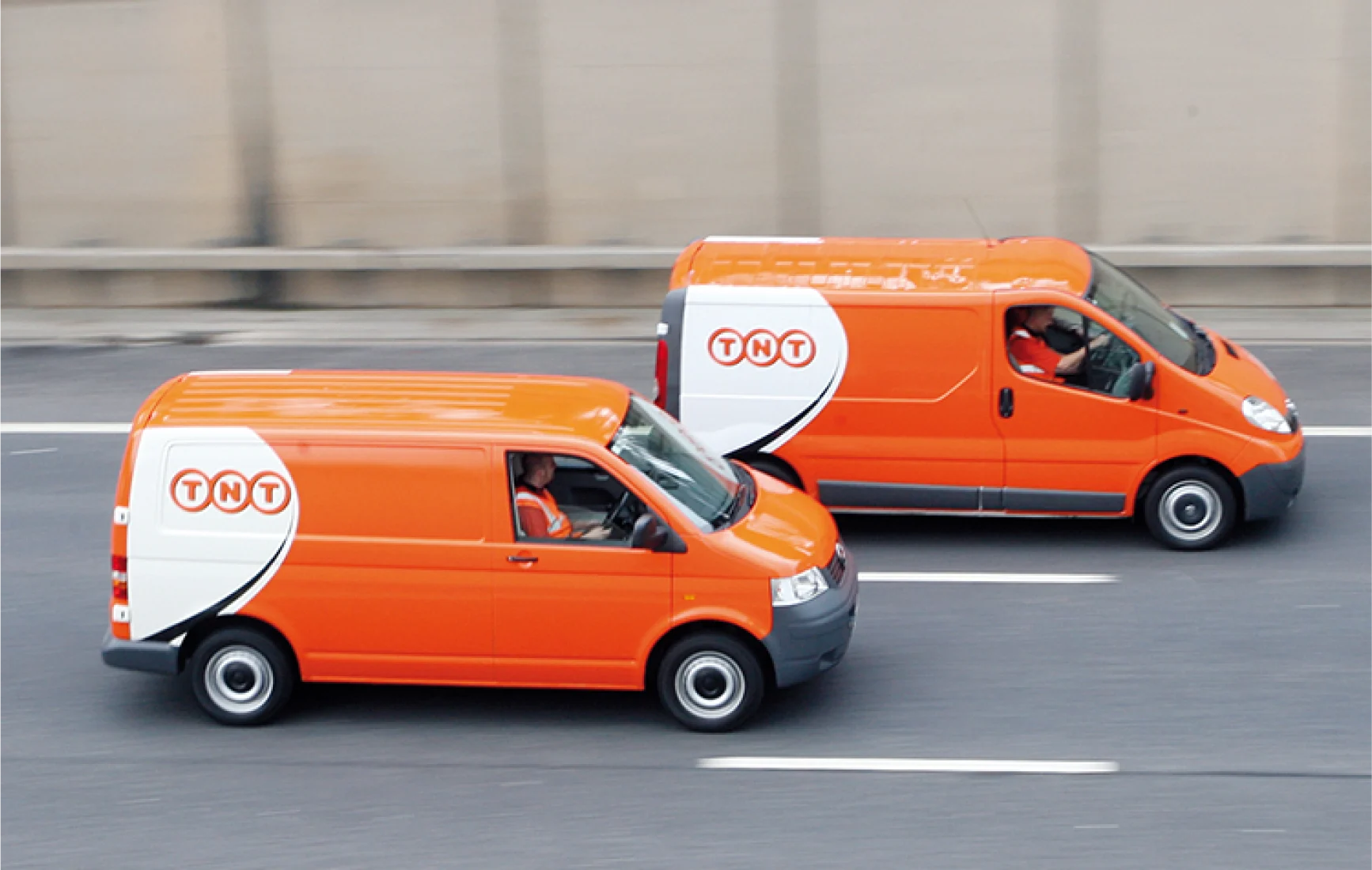 Two TNT Vans on main road