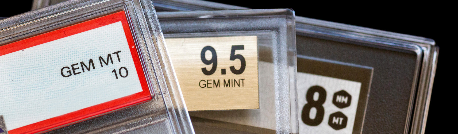 Three graded trading card tops. 10 Gem Mint, 9.5 Gem Mint, 8 Near Mint.