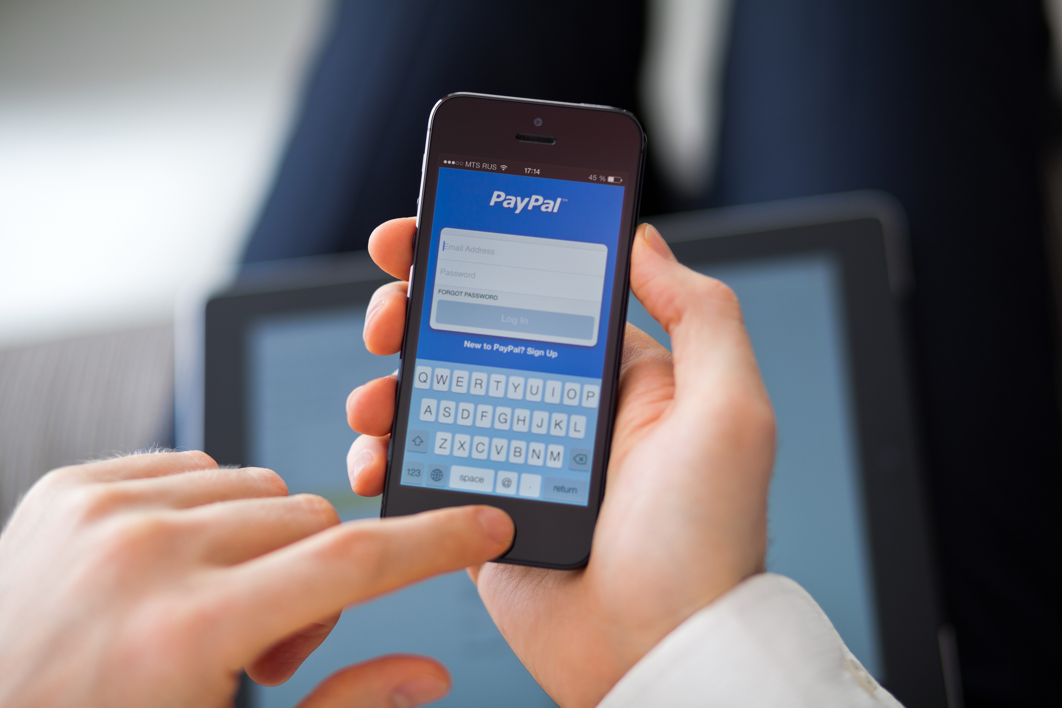Person looks at paypal on their phone.