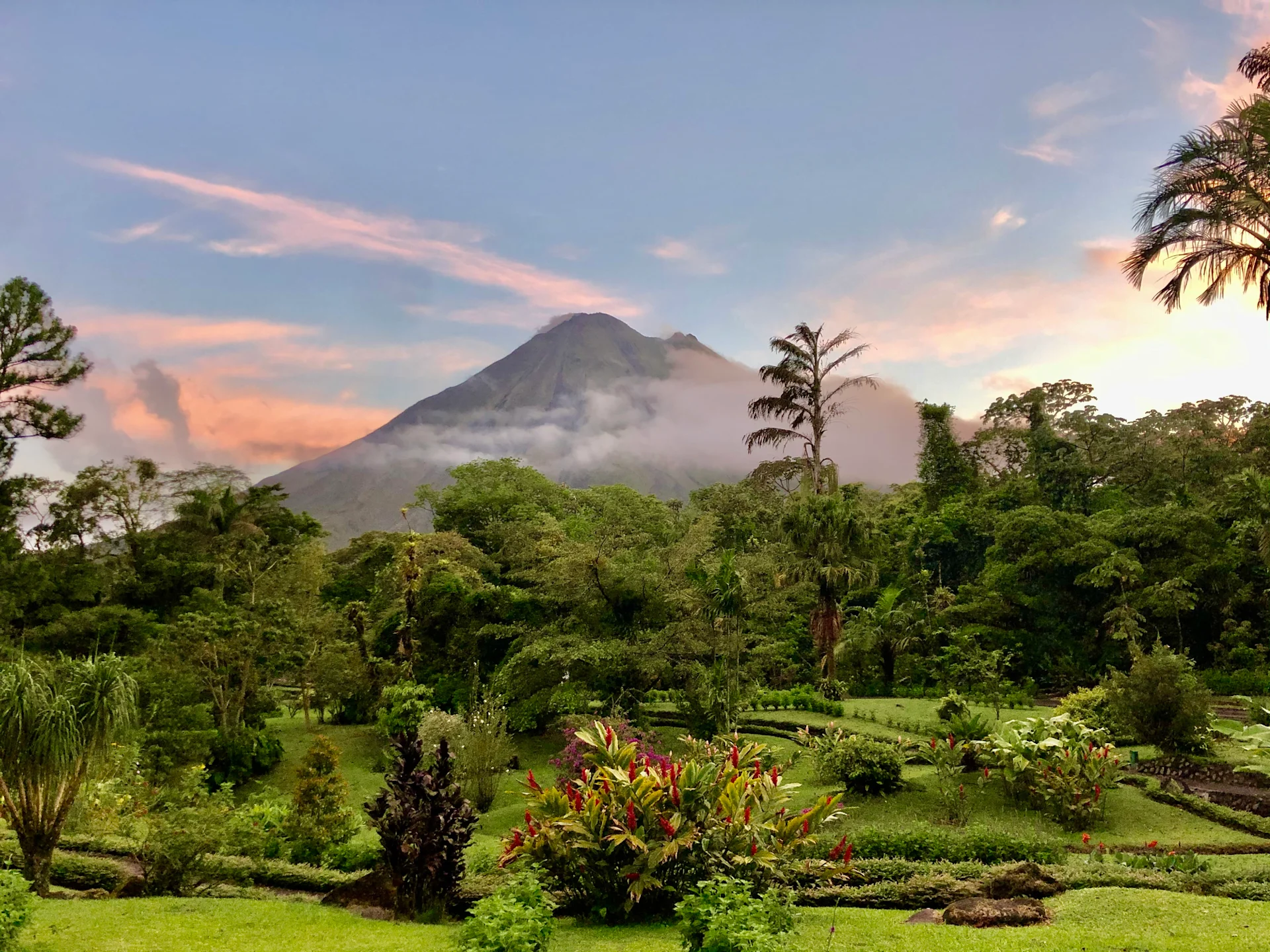 View of bright green trees and a volcano in Costa Rica.