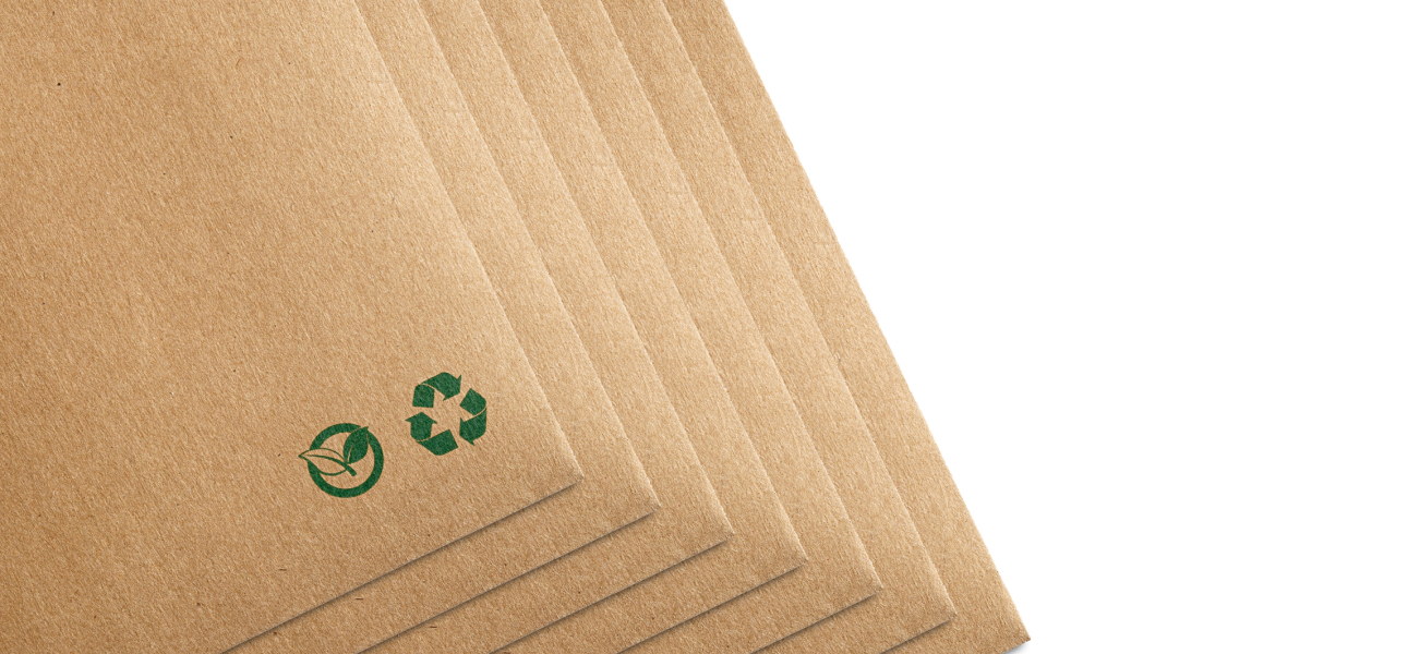 Several cardboard envelopes stacked on top of one another with recycle logo on