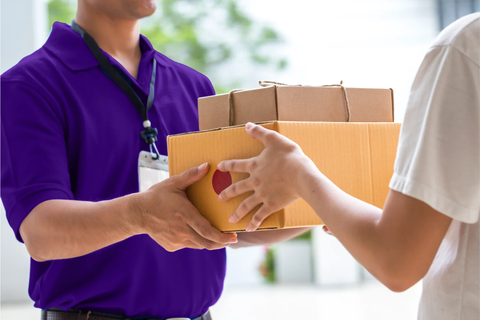 FedEx delivery man handing over parcels at door