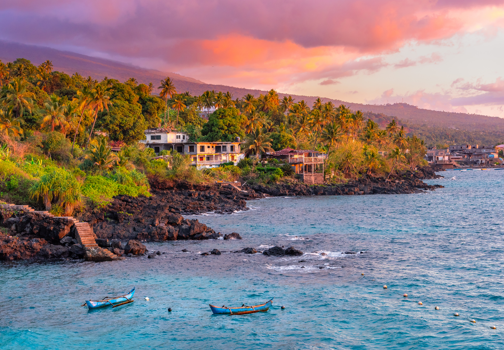 Pink sunset and boats on the water around the Comoros Islands