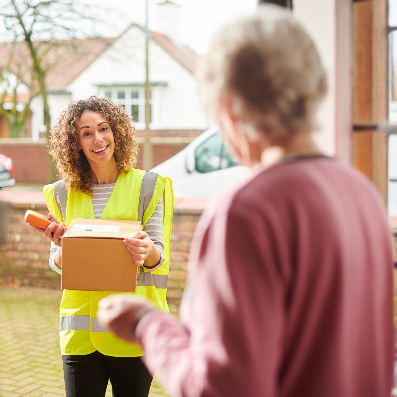 Delivery woman handing over parcel