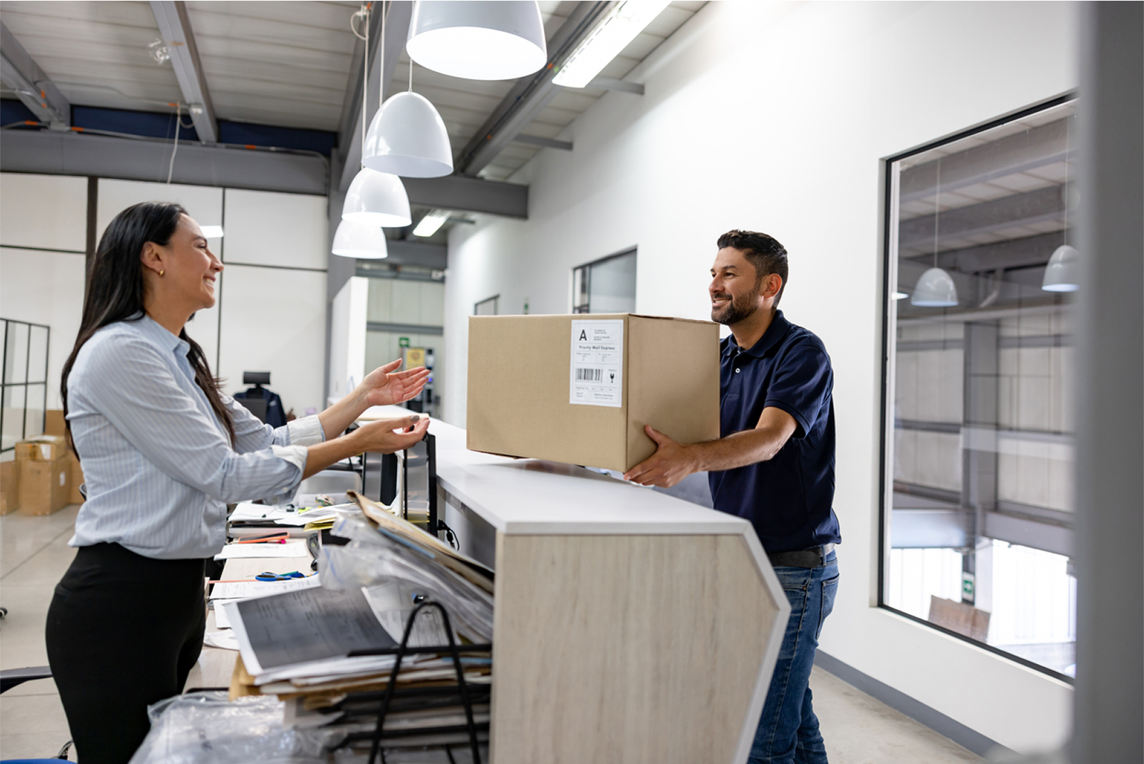 courier handing parcel over desk