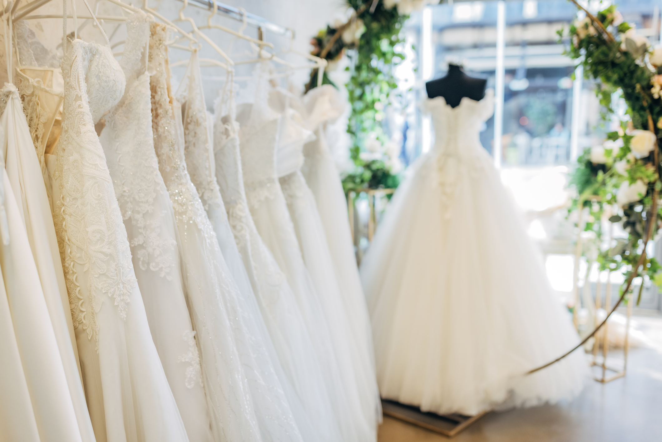 Wedding dresses on display in a bridal store.