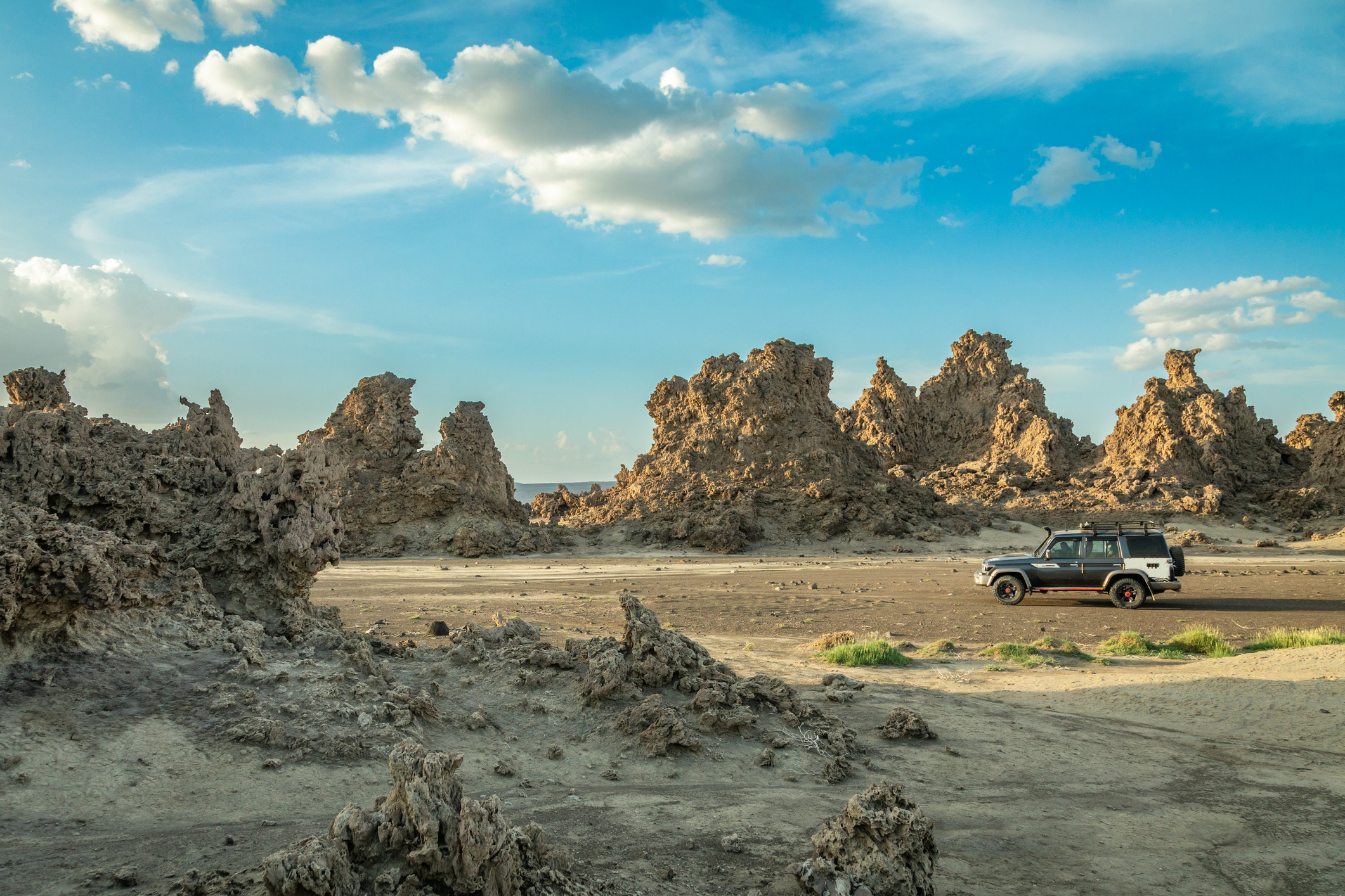 Truck driving through dry, rocky planes in Djibouti.