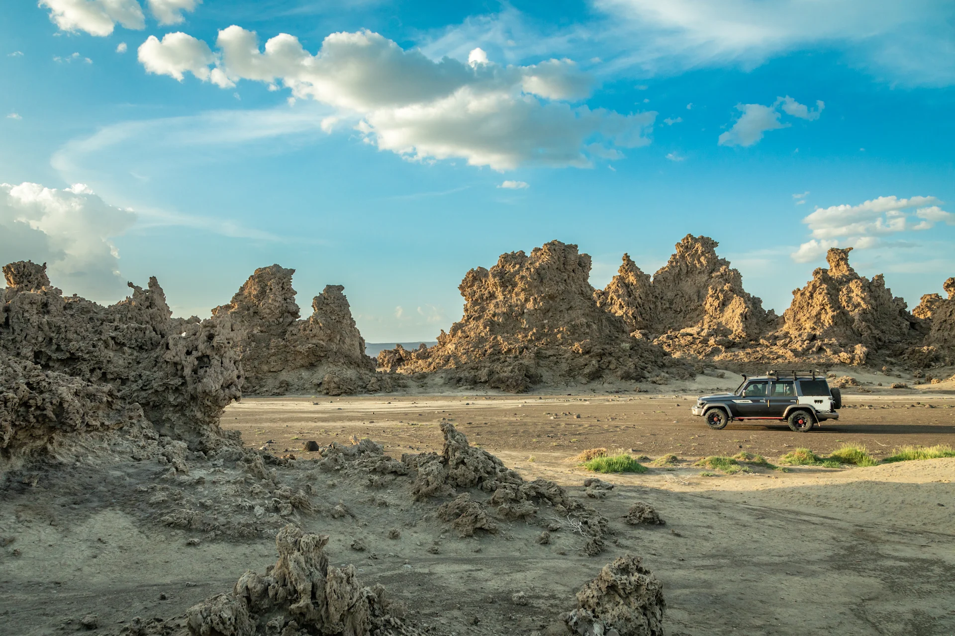Truck driving through dry, rocky planes in Djibouti.