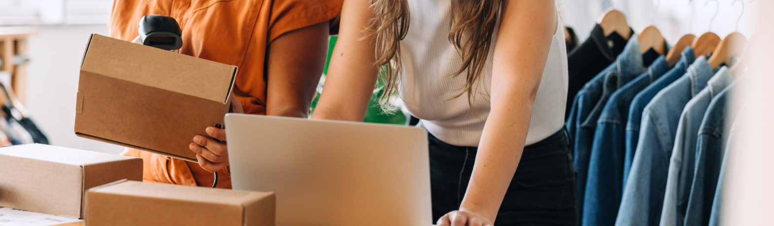 Two people packing and scanning parcels.