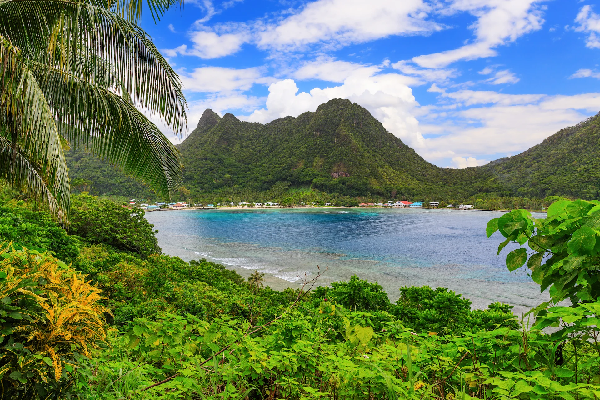 Greenery and a large mountain across a lake in American Samoa