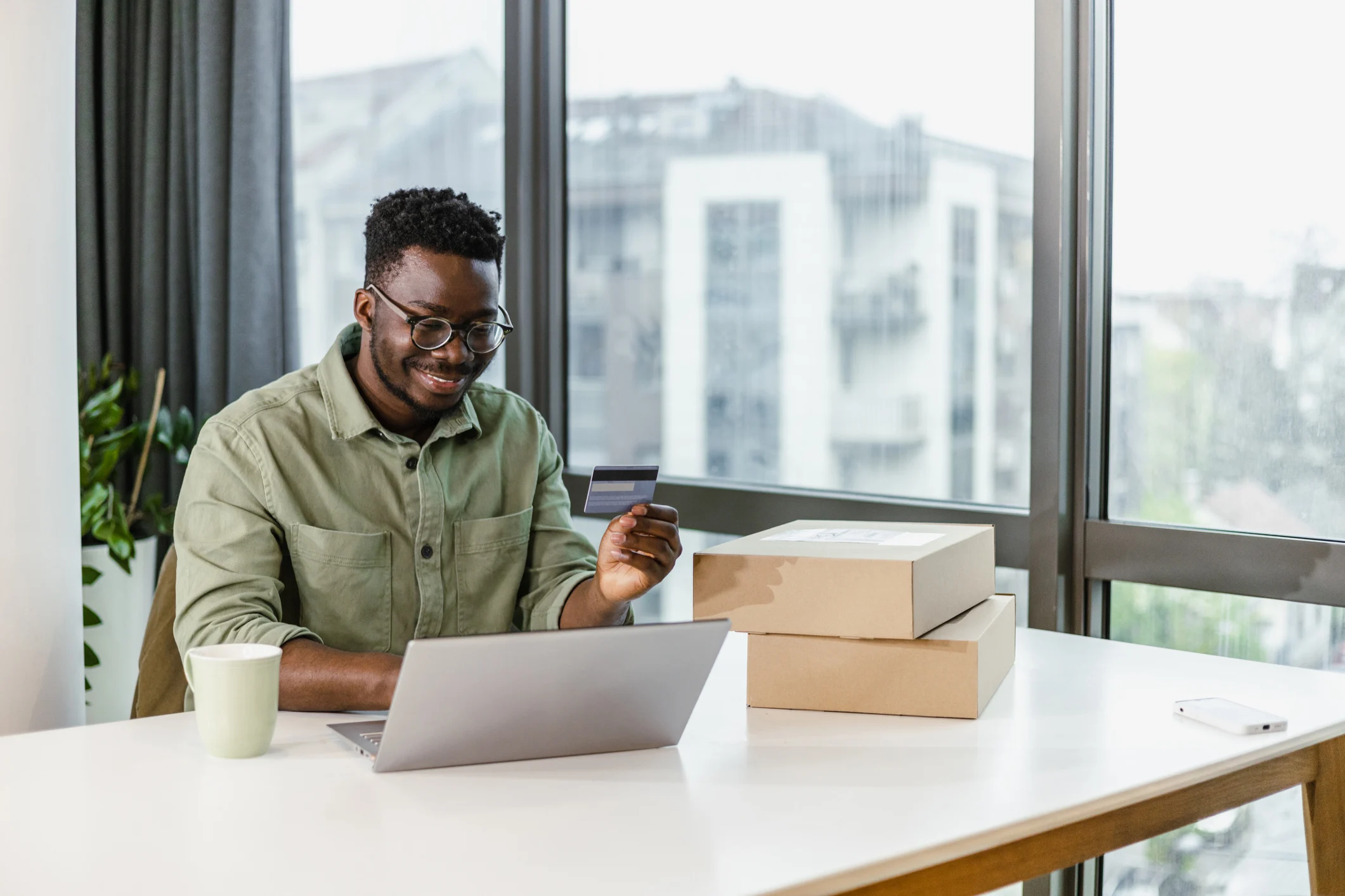 Man with debit card and parcel