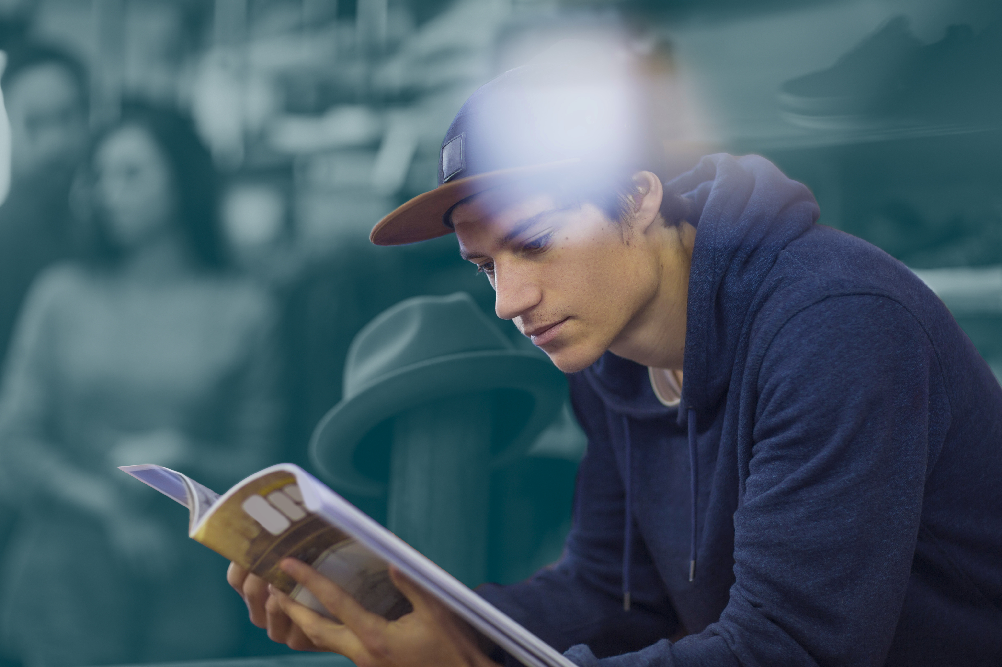 Young man reading book with Asendia brand background