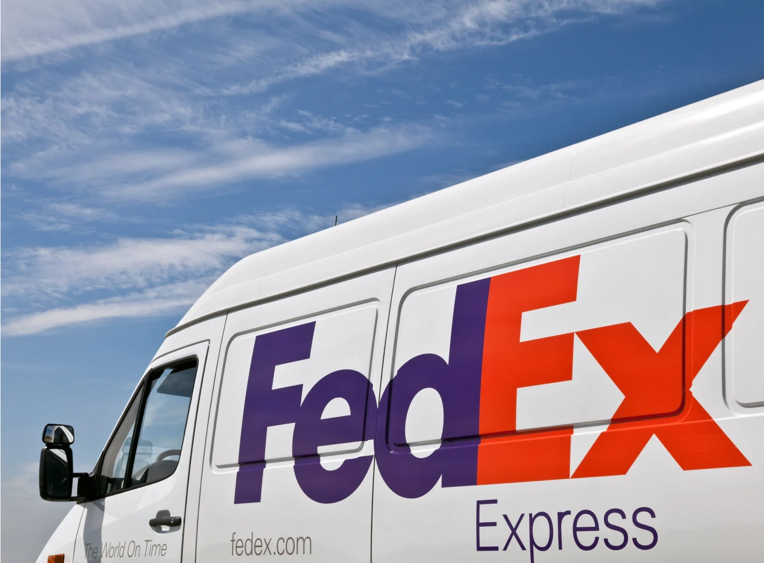 Close up side of FedEx van with company logo on