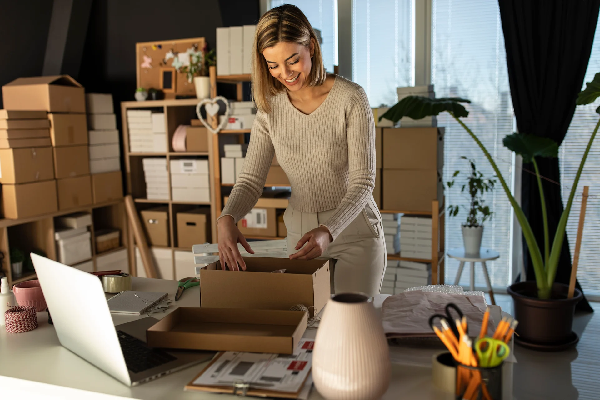 Woman packing parcel at home for delivery