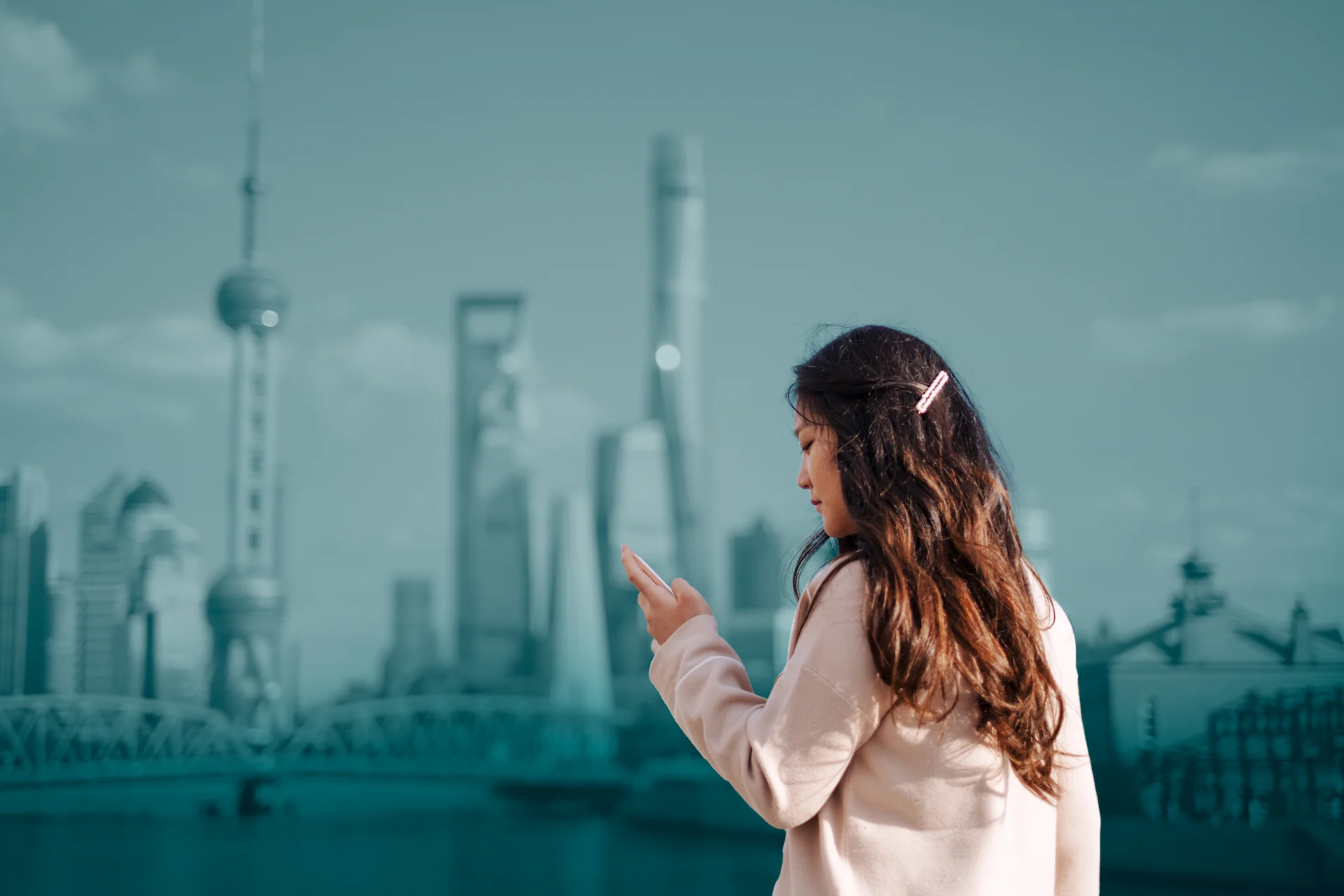 Woman on phone outside of city