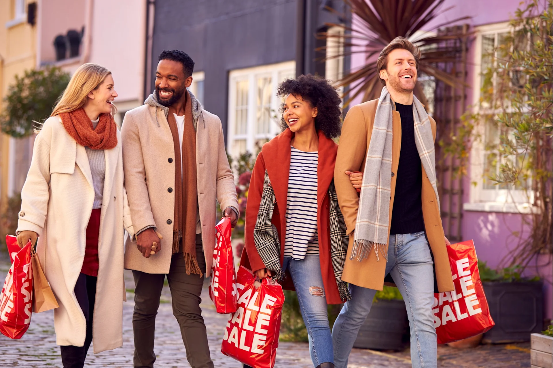 People looking happy holding sales shopping bags