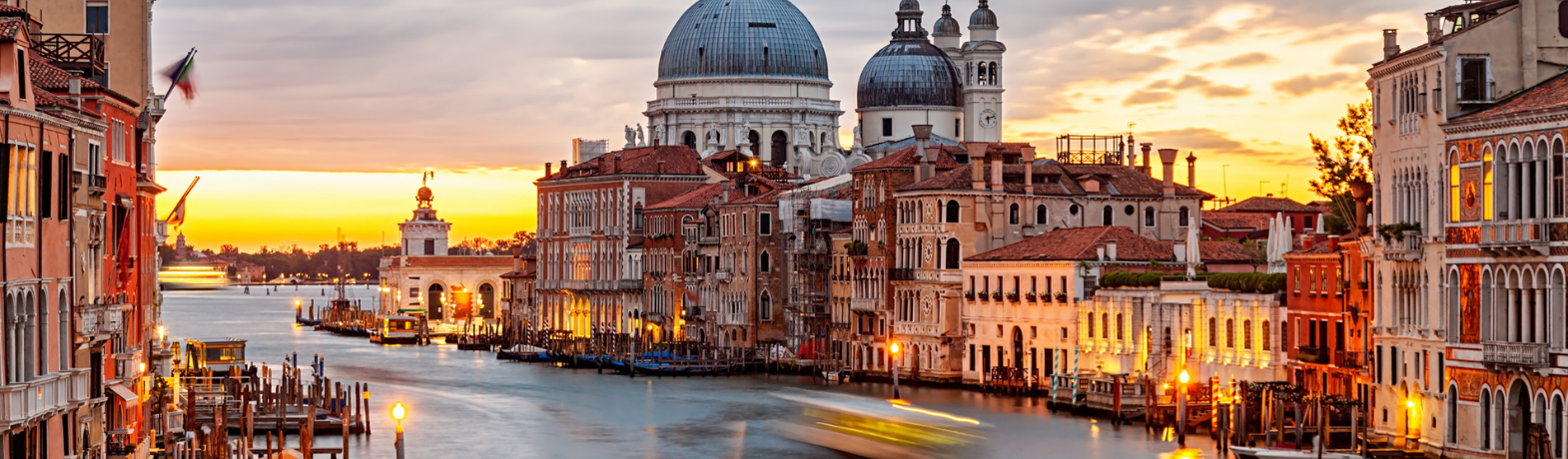 Sunset in venice, Italy. Orange skies and clear water, lots of traditional buildings.