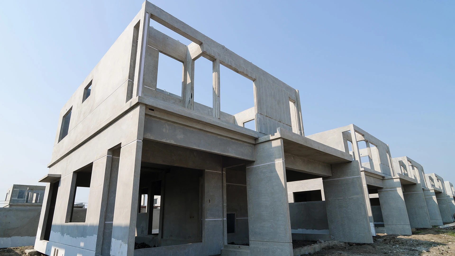 Prefabricated homes take shape on a construction site.