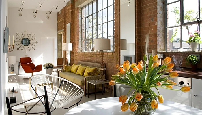 A living room with chair and flowers
