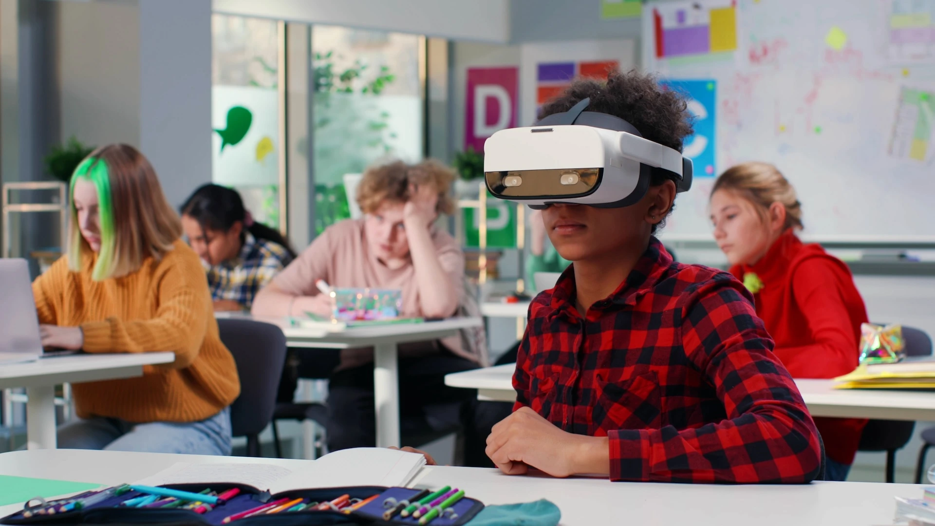 A child in a classroom experiences virtual reality.