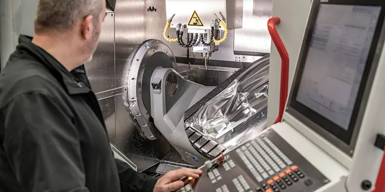 A man looks at a machine.