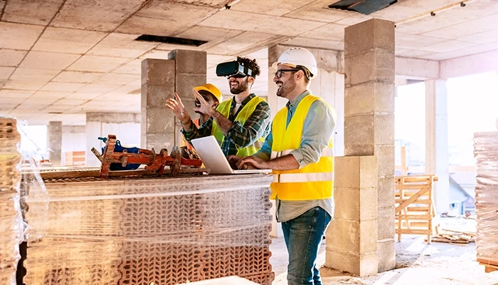 What is XR? Construction workers view plans with VR goggles.