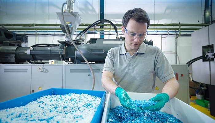 worker in plastics recycling factory