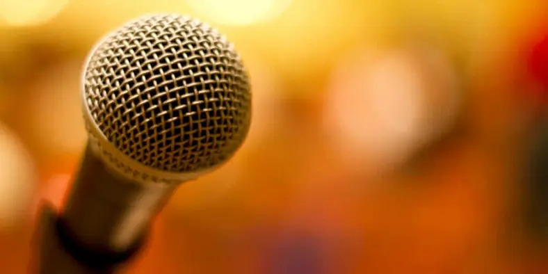 A microphone against a blurred background.