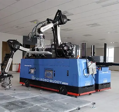 A robotic system helps craftspeople install raised flooring.