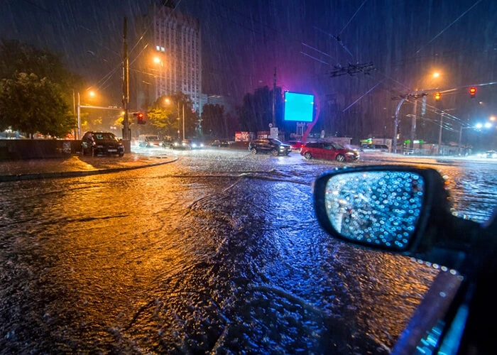 Cars on a flooded road at night