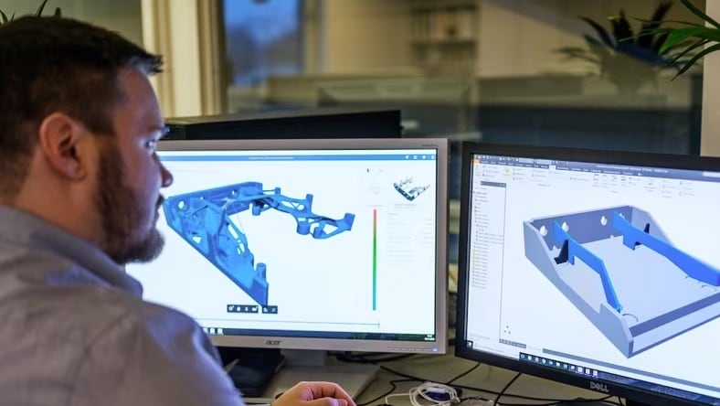 A design engineer reverse engineering a part on his screen.