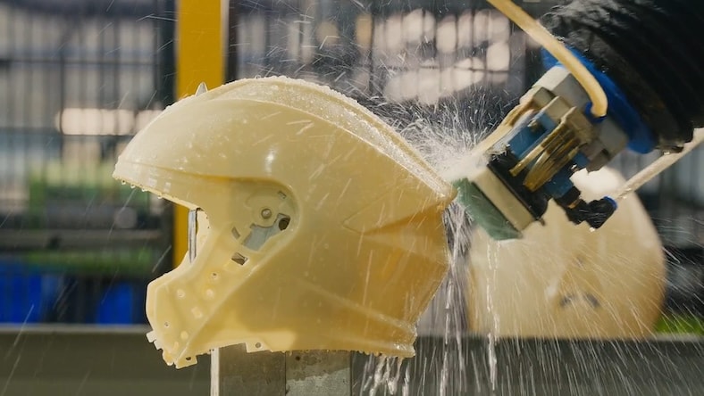 A mountain bike helmet is being manufactured.