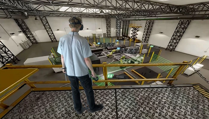 A worker reviews an assembly line with VR.