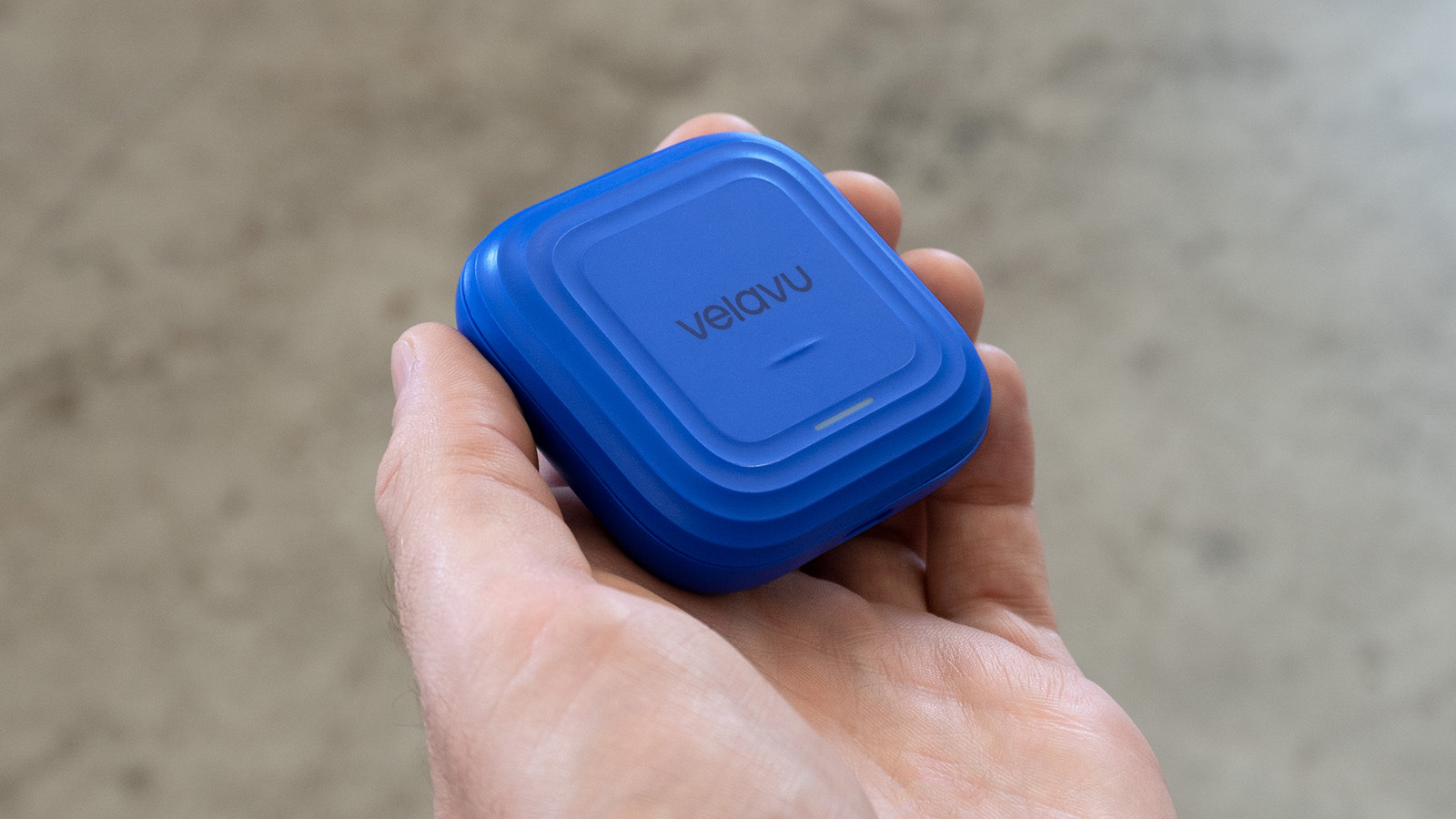 hand holding the Velavu asset tracker