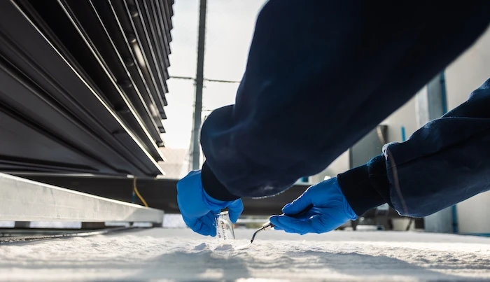 A scientist takes a sample of the calcium carbonate