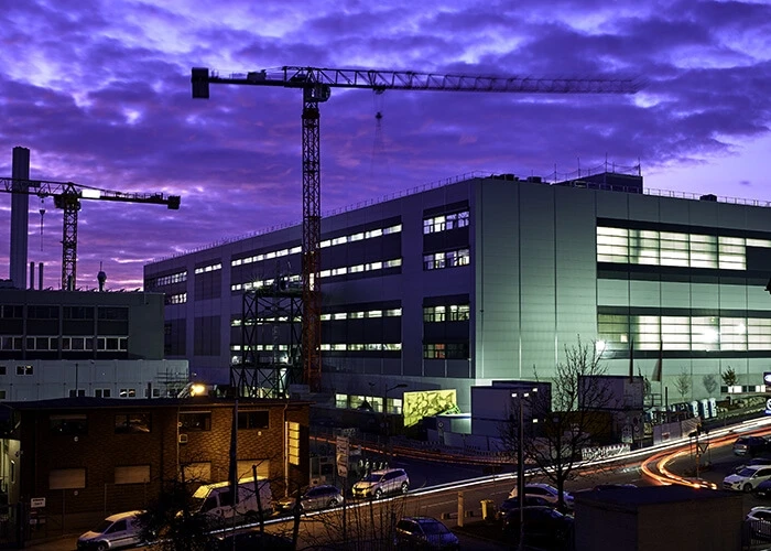 Exterior view of Porsche Taycan factory at nightfall