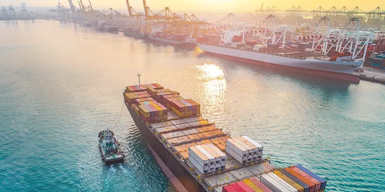 A container ship sails into a port