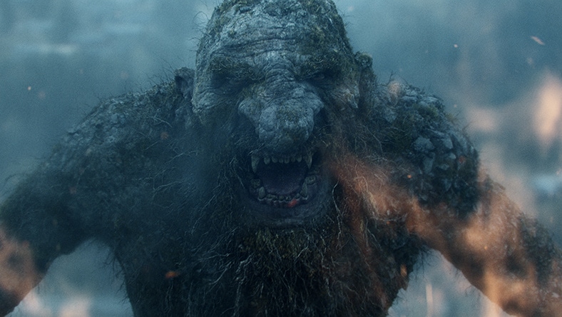 A digitally sculpted monster roars onscreen.