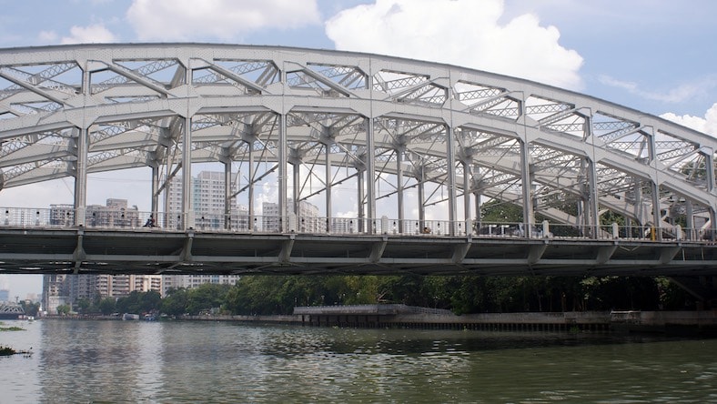 A photo of a steel bridge illustrates the function and placement of trusses.