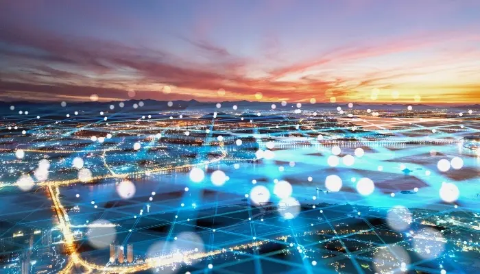 Stylized aerial view of a city at dusk with a digital overlay