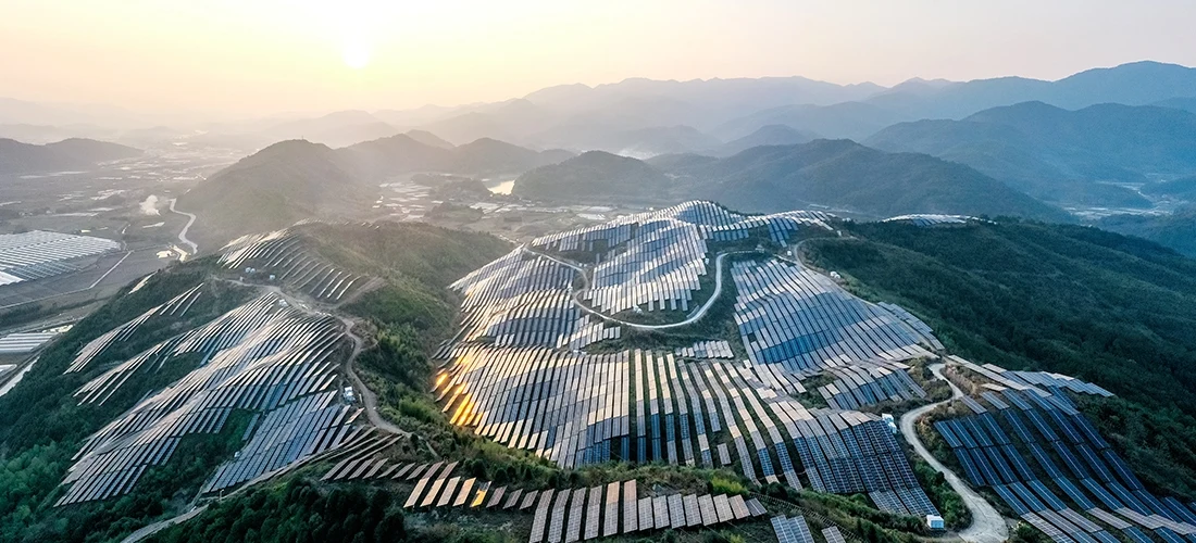 Aerial view of solar panels on hillside
