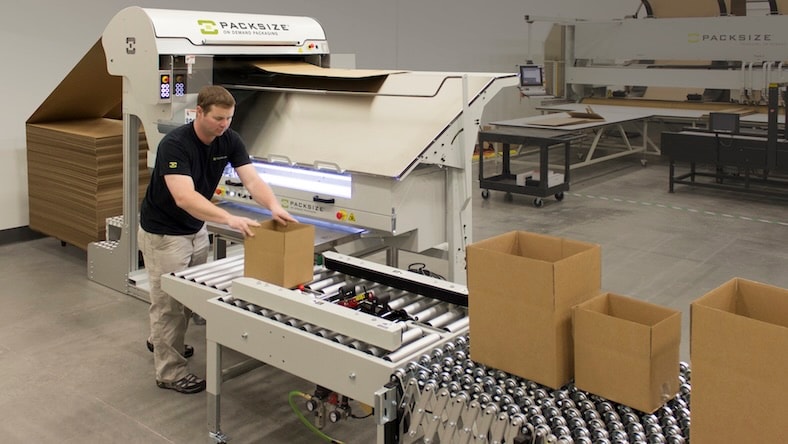 A worker in the Packsize warehouse creates boxes.
