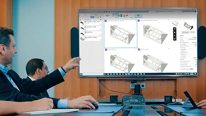 Two designers point to a computer screen showing generative design iterations of a building structure.
