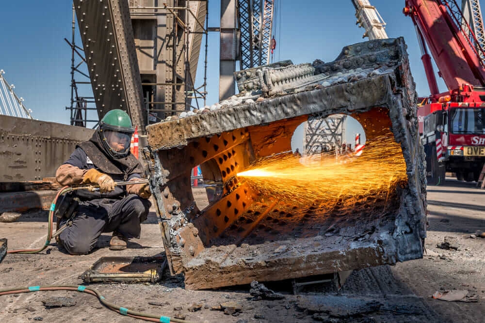 A worker works on the Bay Bridge disassembly